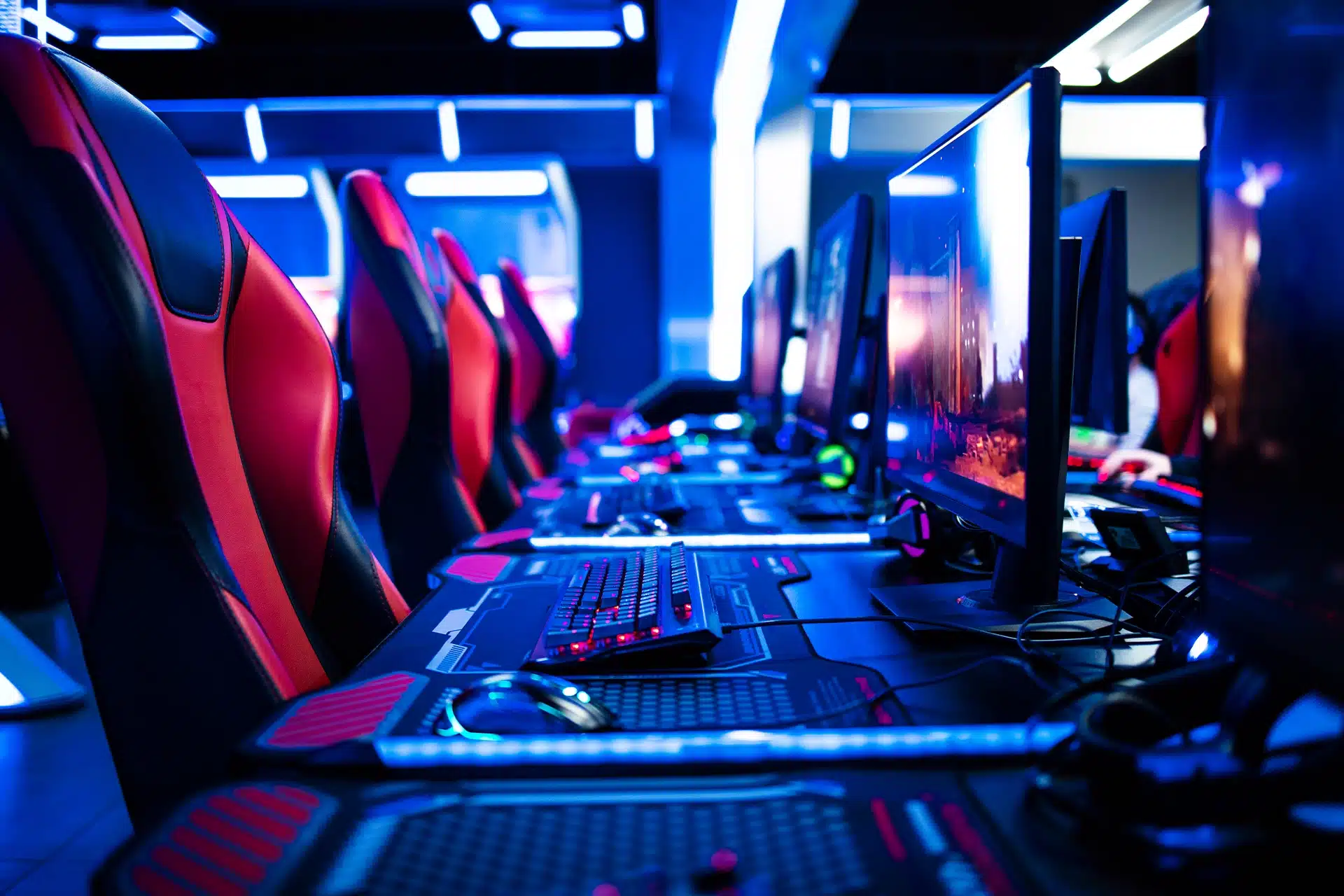row of esports gaming chairs, keyboards, and computers