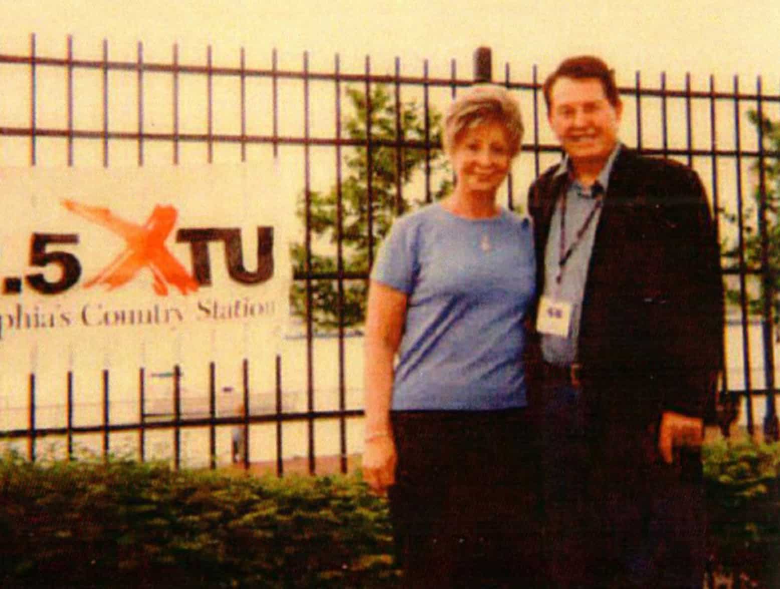 George and Ann Beasley in front of XTU sign