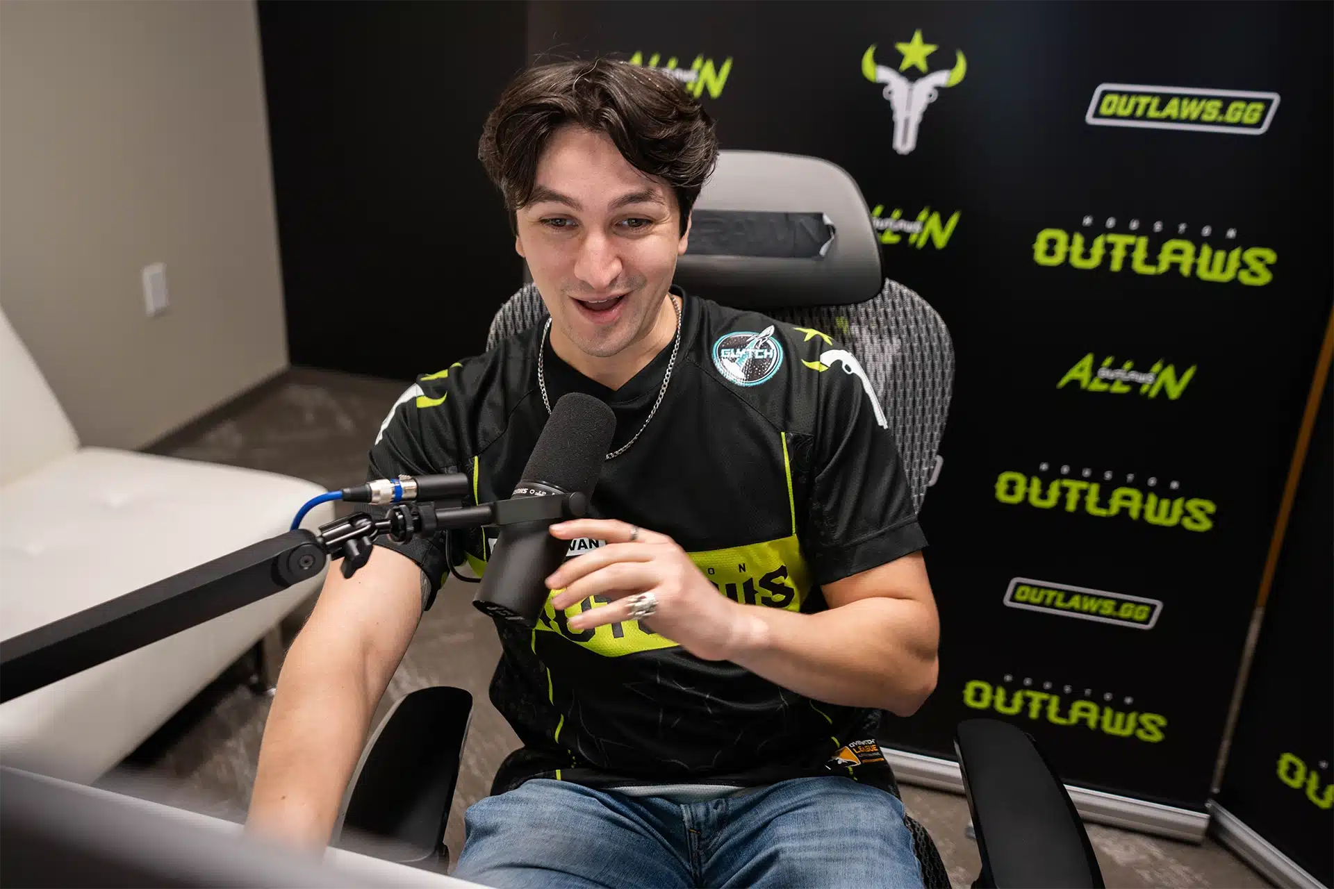 outlaws esports streamer sitting in gaming chair with microphone