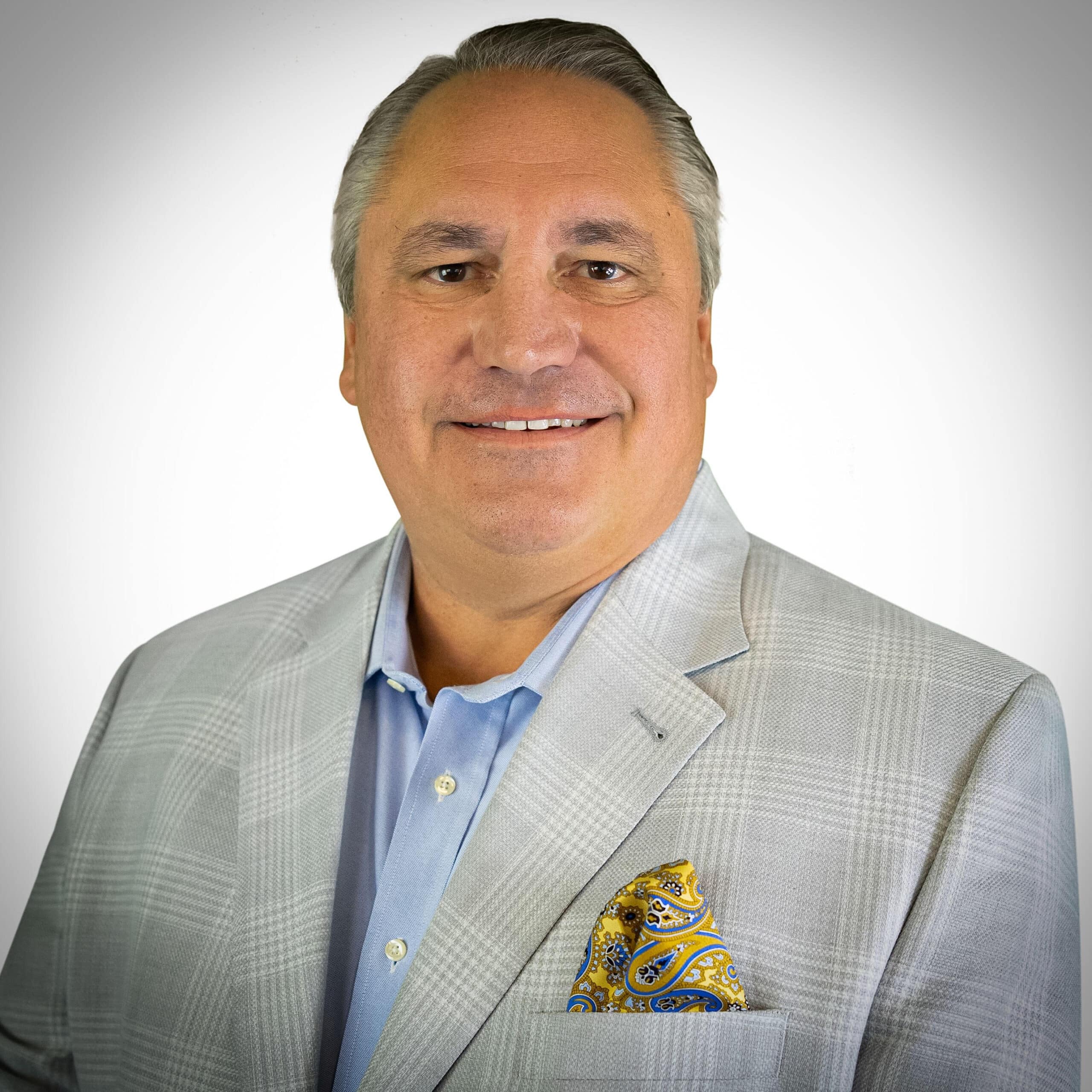 Man in light gray suit jacket.